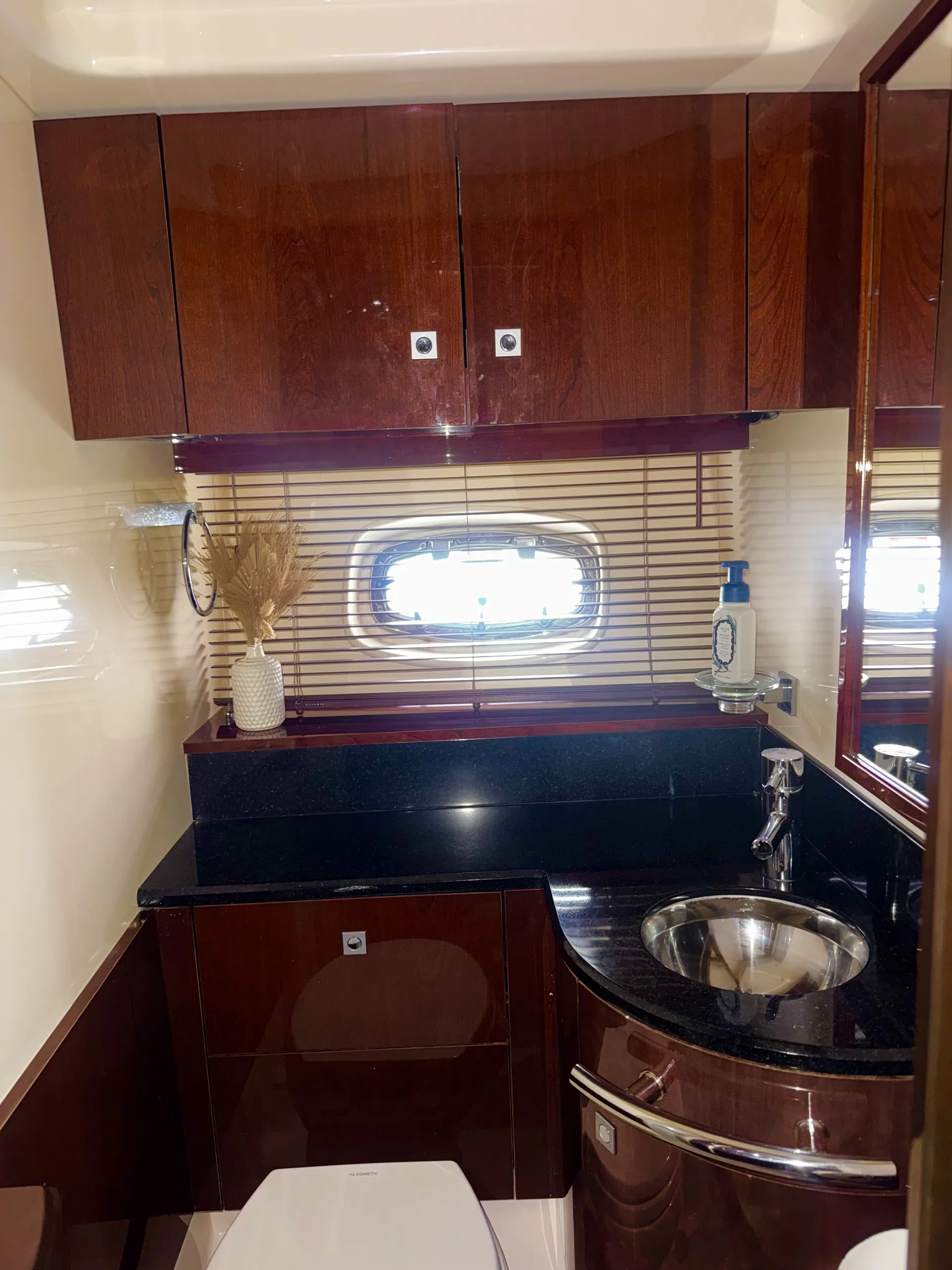 The galley with sink, stone counter and porthole