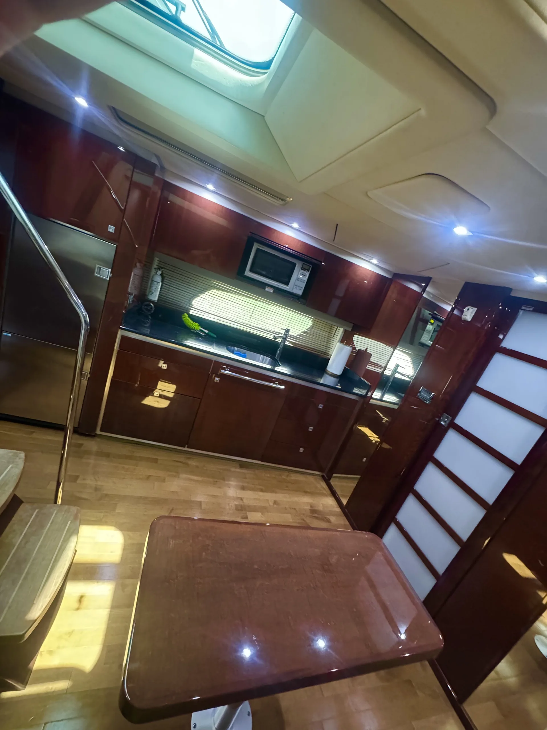 The salon dinette and galley with warm wood joinery