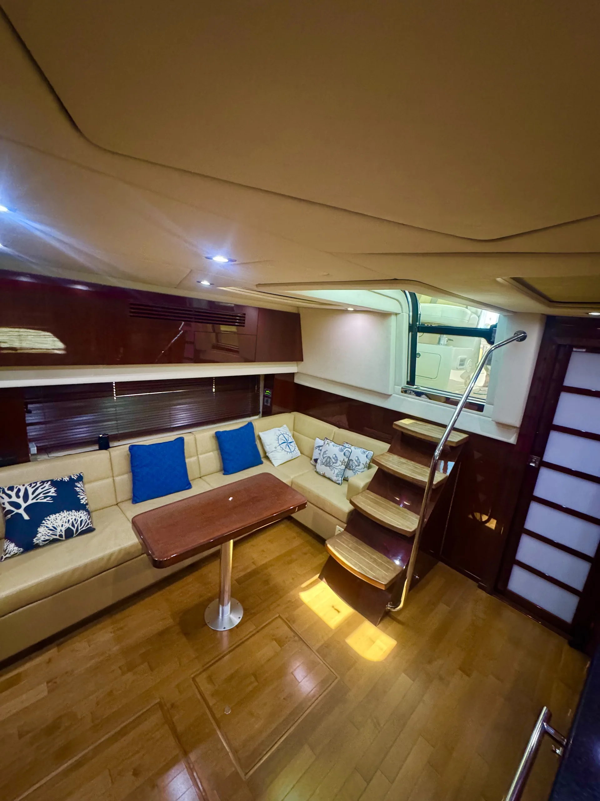 Plush salon seating below deck with natural light