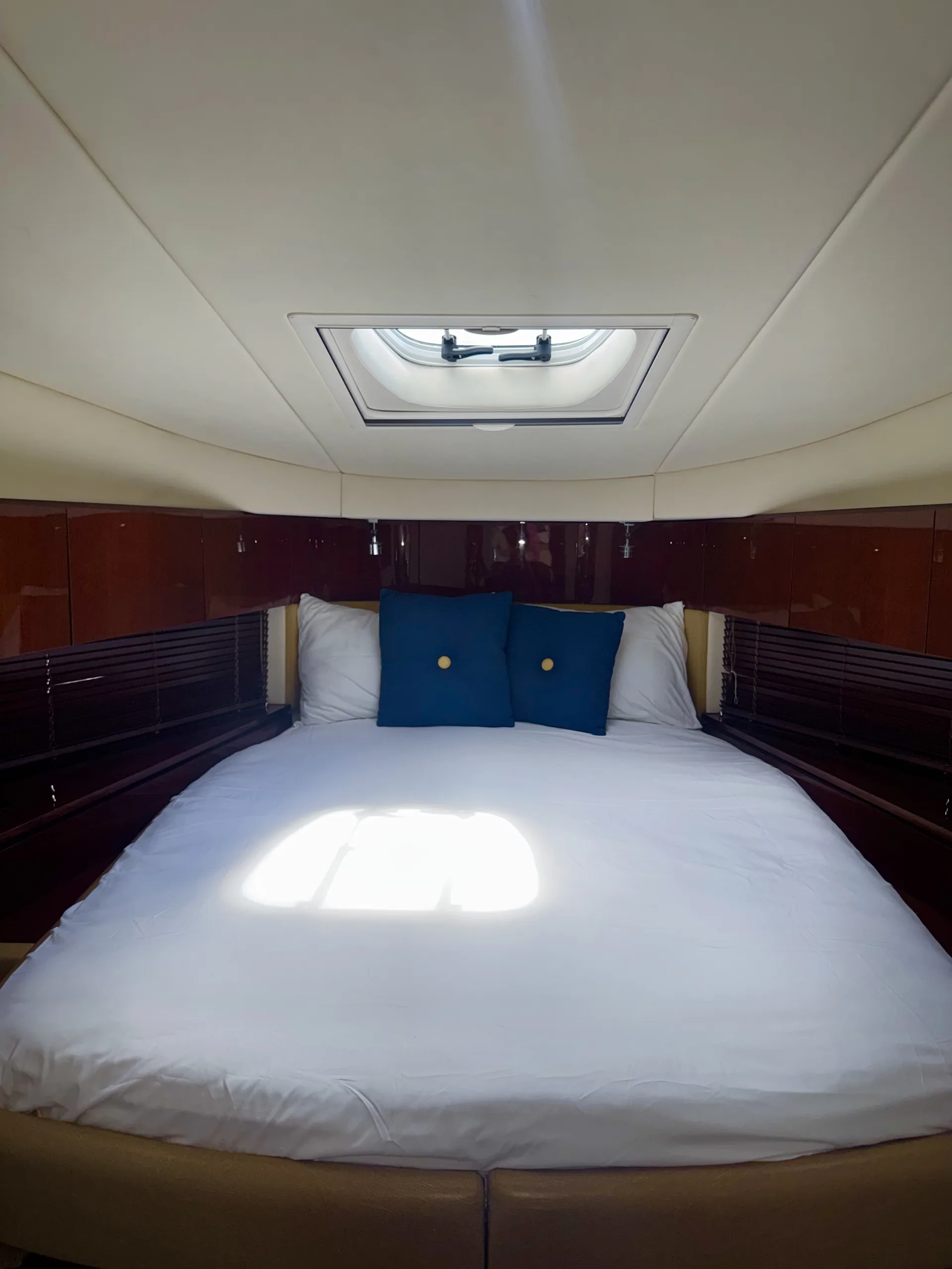 The master stateroom with island berth beneath a deck hatch